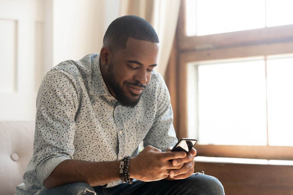 a man searches for a house on his smartphone